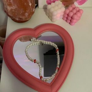 This is a Necklace that has mushrooms(cute) there are pearls